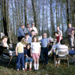 PicnicAtCrumsPondApril1963 - Looks like David and I were having fun, but Mark isn't so sure. Left to right: Mom (Joyce), Pat (in yellow), uncle Jim McConnell in back, Ed McConnell, Rhonda Dold (?), Dad (Walter Crum) in back, Me (Joe), David, Sharon McConnell, Calvin McConnell in back, Mark, Ocie McConnell, Grandpa Crum in back, Lu McConnell (back turned), Lloyd Dold, Pauline Dold. Grandma Crum was the photographer. I remember this picnic; I think it was the only time we had a picnic at the pond.