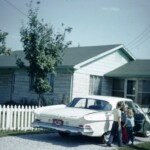Our house, August 1961. Grandpa's new Dodge in the driveway, David, Mark, Pat with Dad.